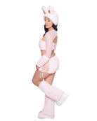 Person wearing a pink bunny costume with ears and gloves on a white background